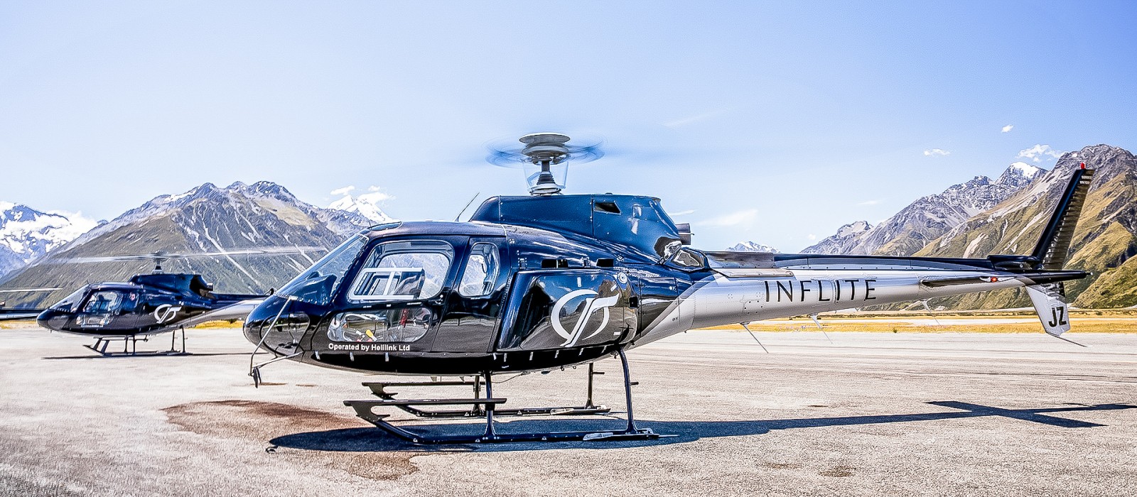 A helicopter and a plane on a runway in Auckland