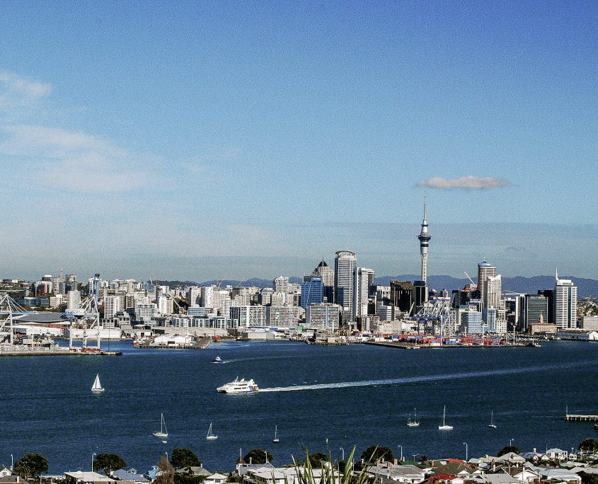 view from the air of Auckland harbour with downtown skyline in background featuring sky tower
